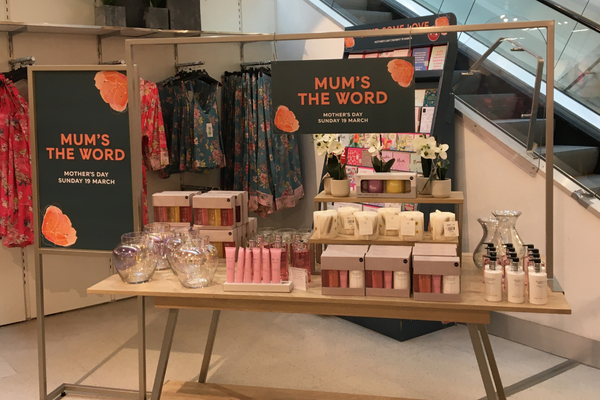 A Mother's Day retail display with hanging POS signage.